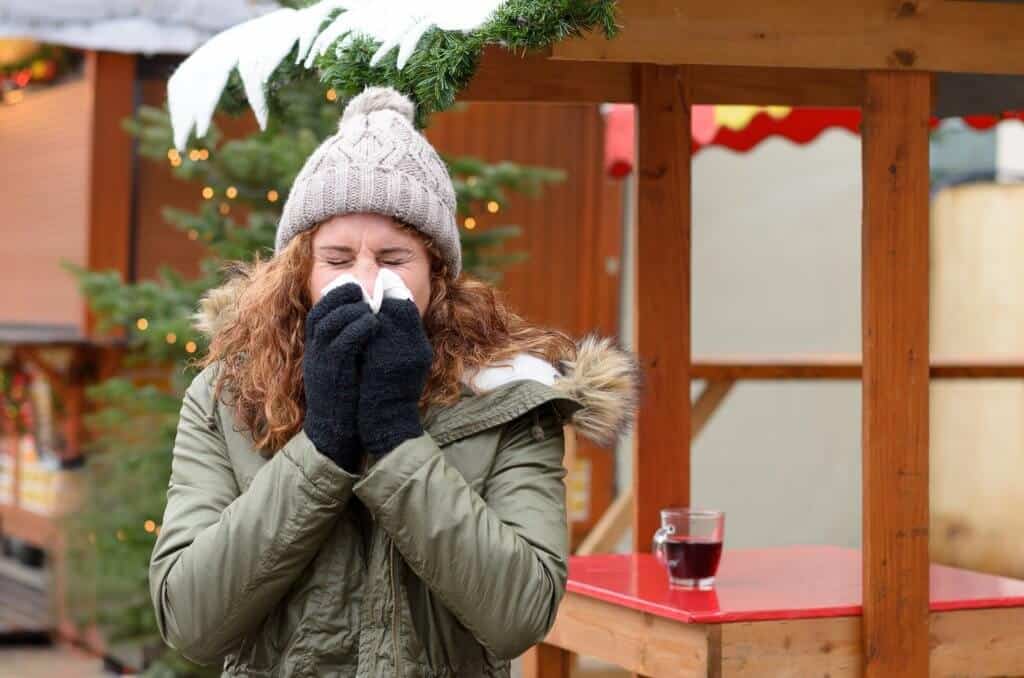 Woman Sneezing Because of winter allergies